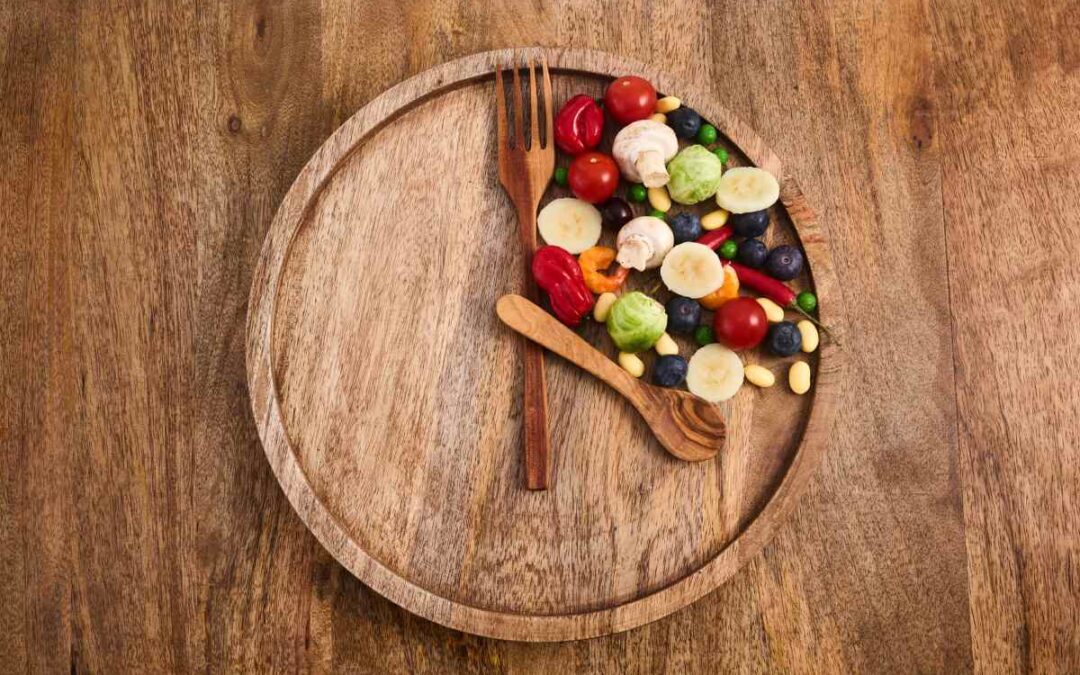 food on wooden plate with wooden spoon and fork