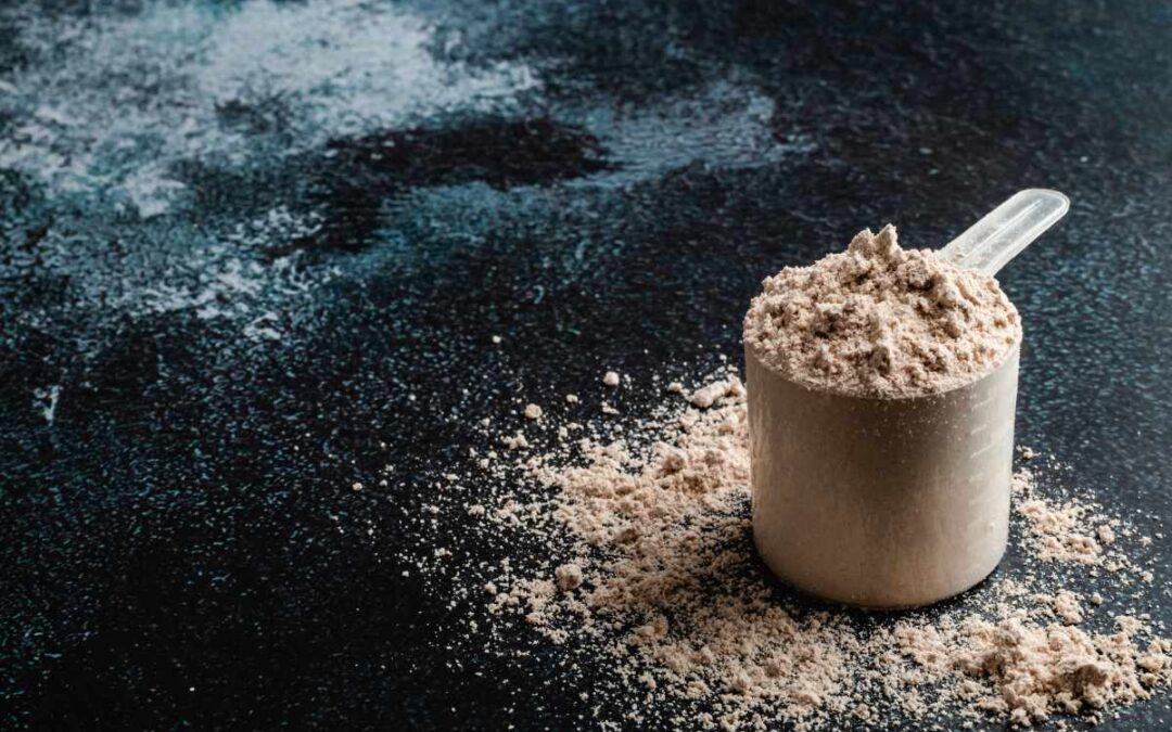 Top view whey protein scoop on dark background